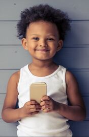 photo of child holding phone